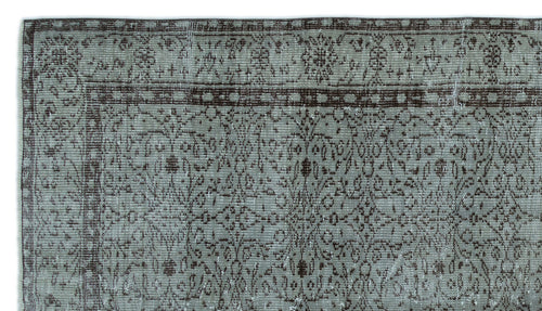 Load image 1 in gallery view. Distressed sage green and dark brown rug with a traditional floral medallion border and intricate vine pattern.