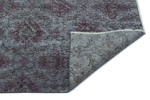 Load image 1 in gallery view. Grey and burgundy distressed medallion rug with a folded corner showing the woven backing on a white background.