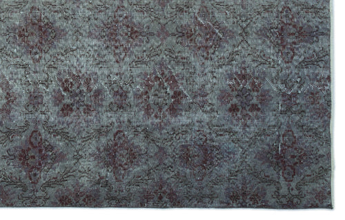 Load image 1 in gallery view. Distressed charcoal and deep red rug with a repeating floral medallion pattern.
