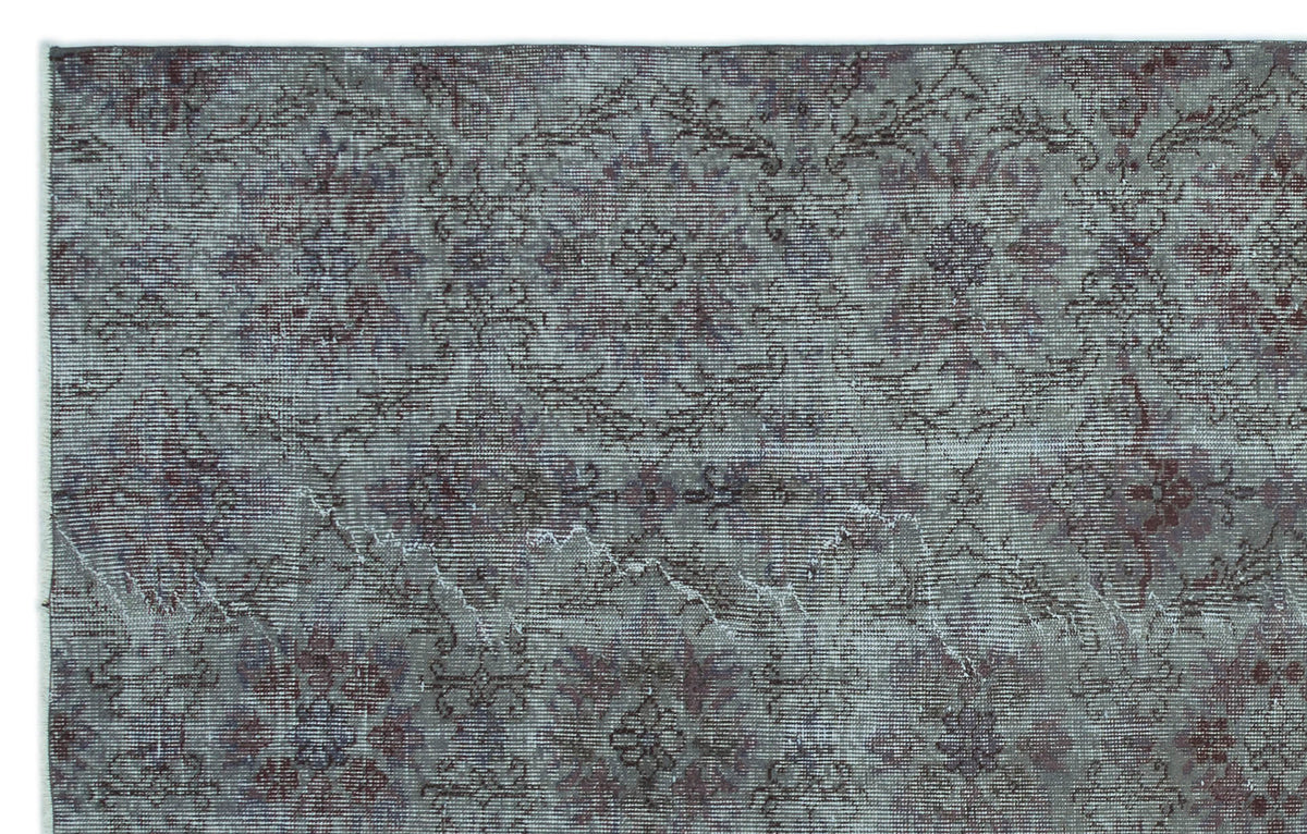 Distressed slate blue and burgundy rug with a faded traditional floral medallion pattern.