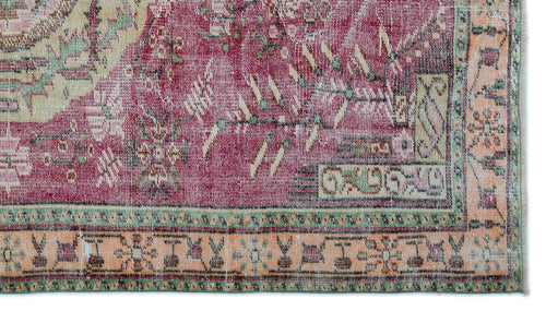 Load image 1 in gallery view. Distressed magenta, cream, and sage green rug with a traditional floral medallion pattern and ornate border.