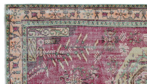 Load image 1 in gallery view. Magenta and peach vintage-style rug with a distressed geometric border and traditional floral motifs.