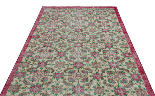 Load image 1 in gallery view. Cream rug with a red border and a repeating floral medallion pattern in red, green, and brown on a white background.