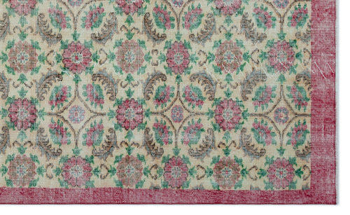 Load image 1 in gallery view. Cream rug with a repeating floral medallion pattern in red, green, and brown, featuring a solid red border.