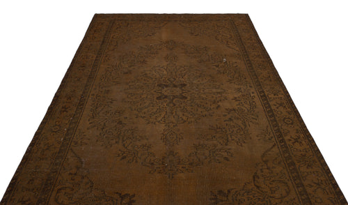 Load image 1 in gallery view. Monochromatic dark brown rug with a traditional central medallion and ornate floral border on a white background.