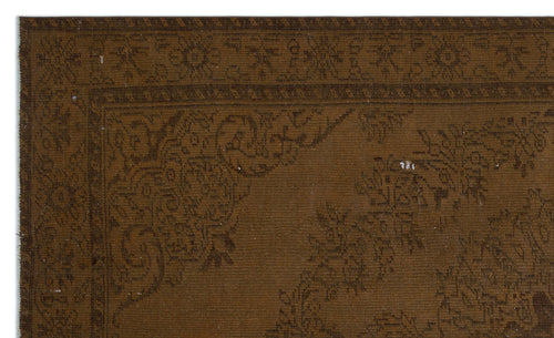 Load image 1 in gallery view. Dark brown rug with a tonal floral medallion pattern and a decorative border.