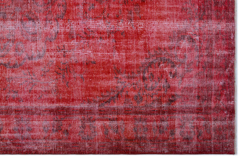 Load image 1 in gallery view. Distressed red and dark pink overdyed rug with a faded traditional medallion pattern.