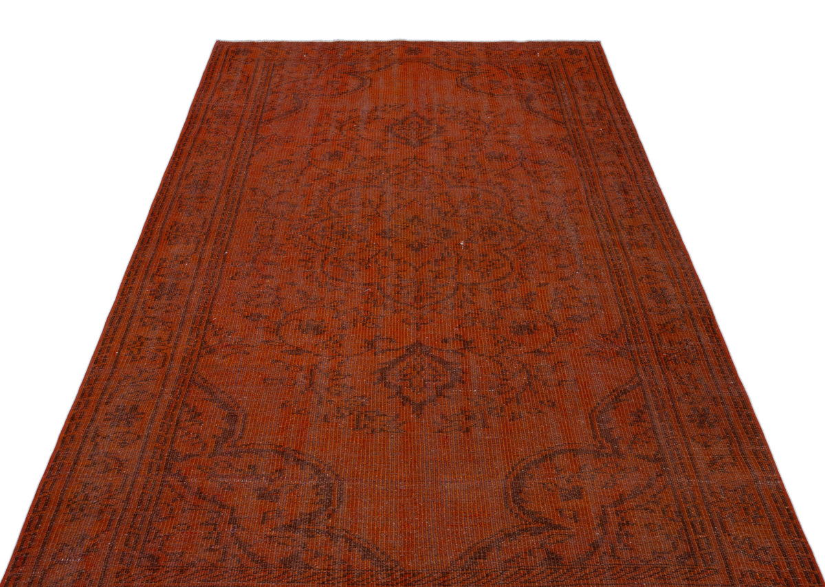 Rust-colored vintage-style rug with a dark brown central medallion and intricate floral border on a white background.