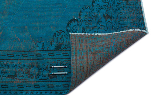 Load image 1 in gallery view. Teal and black distressed traditional rug with a folded corner, isolated on a white background.