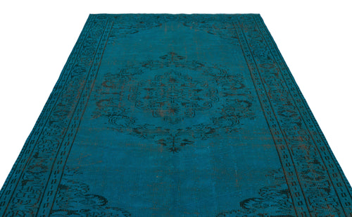 Load image 1 in gallery view. Teal distressed rug with a dark charcoal central medallion and ornate border pattern on a white background.