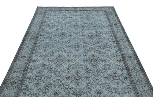 Load image 1 in gallery view. Light blue and charcoal grey rug with a traditional distressed floral medallion pattern and a bordered edge.