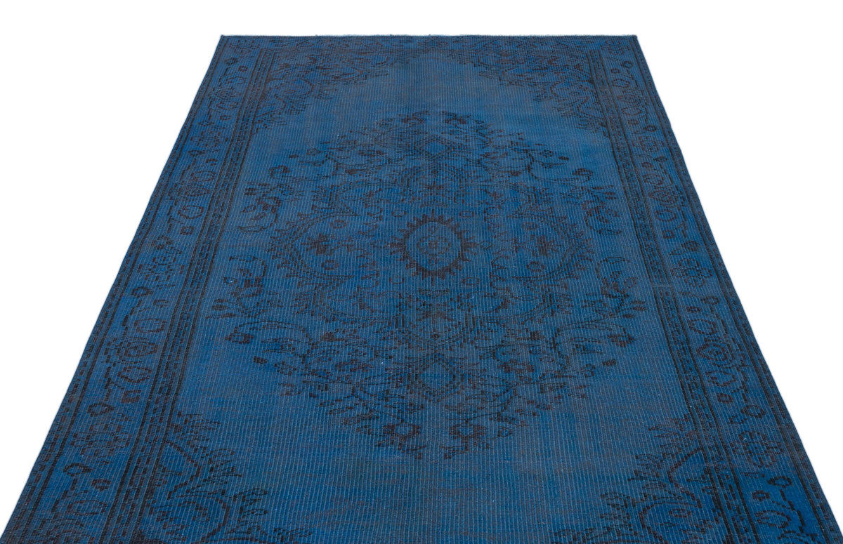 Deep blue distressed rug with a dark charcoal traditional floral medallion and border pattern on a white background.