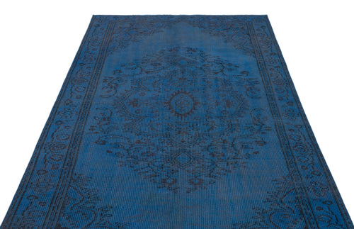 Load image 1 in gallery view. Deep blue distressed rug with a dark charcoal traditional floral medallion and border pattern on a white background.