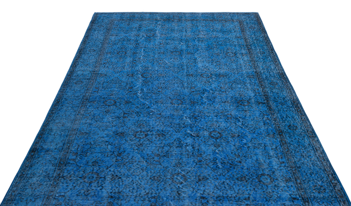 Deep blue vintage-style rug with a distressed traditional medallion pattern and a dark border on a white background.