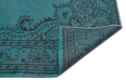 Load image 1 in gallery view. Teal and black rug with a traditional ornate medallion pattern, shown with a corner folded over on a white background.