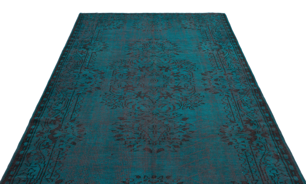 Teal and black distressed rug with a traditional central medallion and ornate border on a white background.
