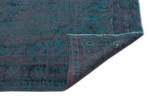 Load image 1 in gallery view. Teal and dark purple distressed vintage-style rug with a folded corner on a white background.