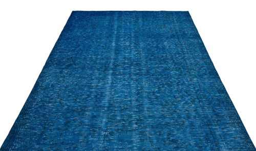 Load image 1 in gallery view. Solid blue vintage-style rug with a distressed, faded texture and subtle dark geometric border details.