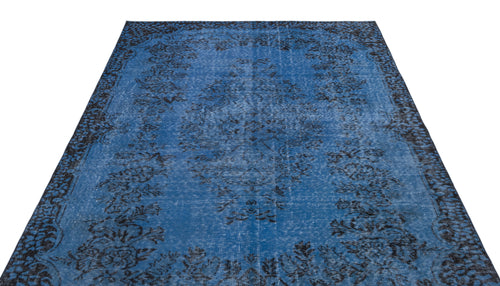 Load image 1 in gallery view. Blue and black distressed rug with a traditional floral medallion pattern on a white background.