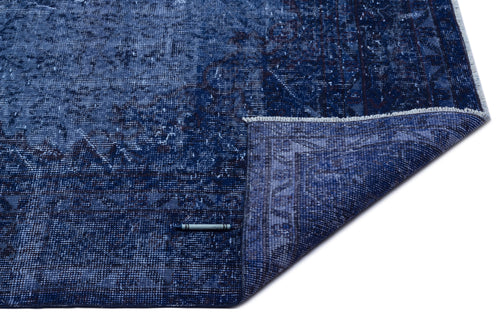 Load image 1 in gallery view. Navy blue distressed traditional rug with a folded corner revealing the underside, isolated on a white background.