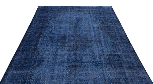 Load image 1 in gallery view. Monochromatic navy blue rug with a distressed, traditional medallion pattern on a white background.