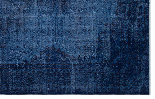 Load image 1 in gallery view. Deep blue distressed rug with a faded traditional medallion pattern and geometric border.