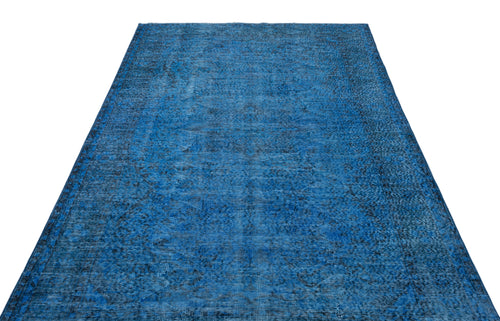 Load image 1 in gallery view. Deep blue vintage-style area rug with a distressed, faded traditional medallion pattern on a white background.
