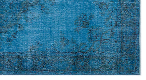 Load image 1 in gallery view. Bright blue rug with a distressed, faded floral medallion pattern and a dark border.