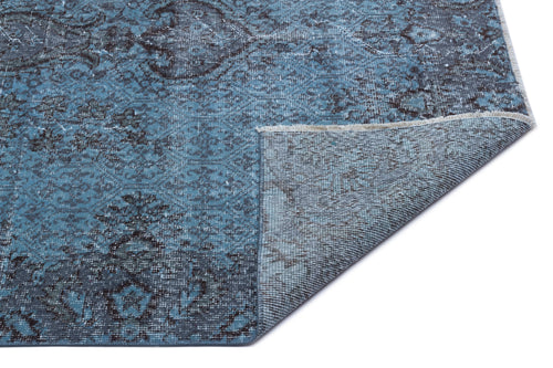 Load image 1 in gallery view. Blue and charcoal distressed traditional medallion rug with a folded corner showing the woven backing.