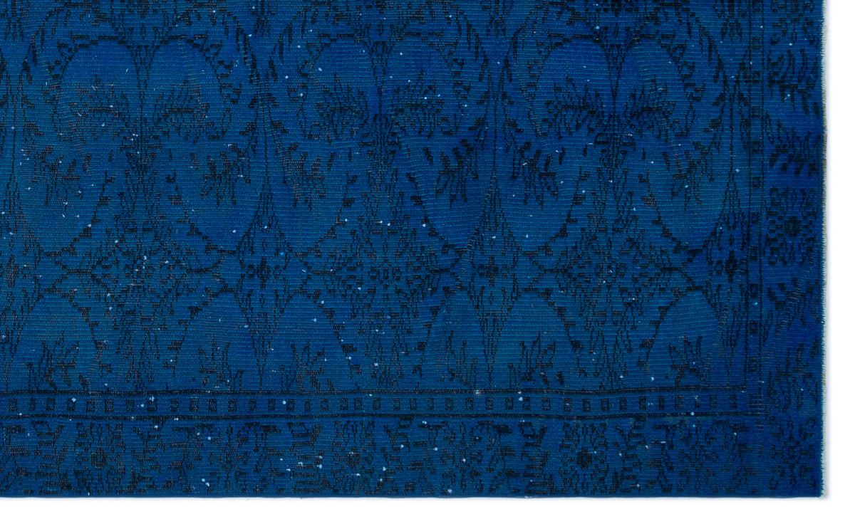 Deep blue rug with a black ornate floral medallion pattern and a decorative border.