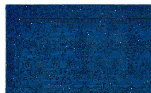 Load image 1 in gallery view. Deep blue rug with a black geometric diamond and floral medallion pattern and a distressed finish.