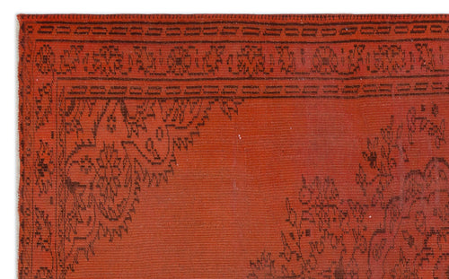 Load image 1 in gallery view. Rust-red rug with a black linear border and intricate floral corner medallion pattern.