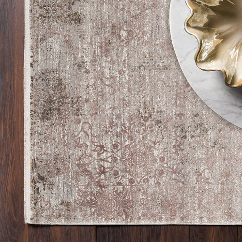 Load image 1 in gallery view. Distressed taupe and grey rug with a faded floral medallion pattern, placed on a dark wood floor with a marble accent.