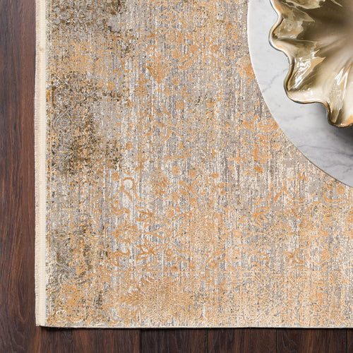 Load image 1 in gallery view. Grey and gold distressed floral medallion rug on a dark wood floor with a marble table edge.