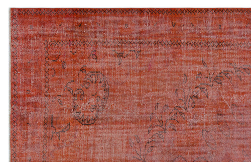 Load image 1 in gallery view. Distressed terracotta rug with a faded black floral medallion pattern and a thin geometric border.