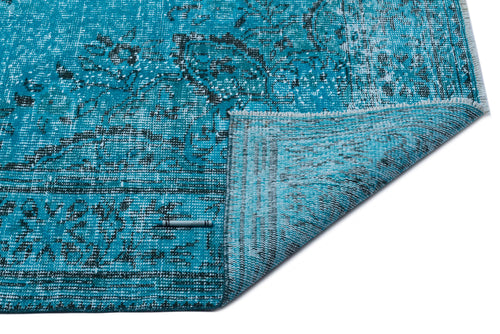 Load image 1 in gallery view. Turquoise and black distressed traditional rug with a folded corner showing the underside, isolated on white.