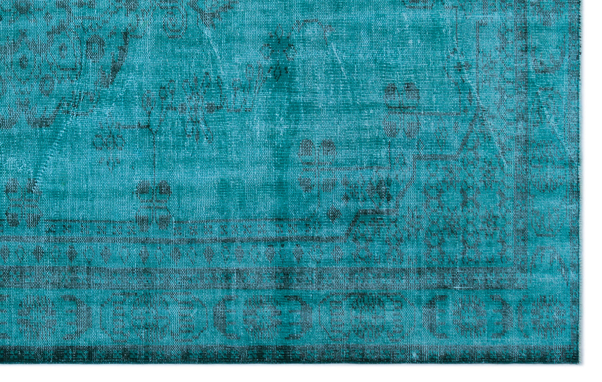 Teal vintage-style rug with a distressed, faded traditional medallion pattern and a dark border.