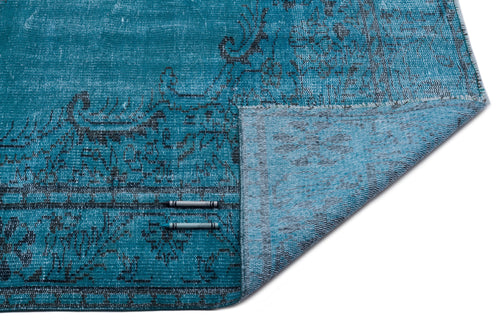 Load image 1 in gallery view. Teal and black distressed medallion rug with a folded corner revealing the woven backing.