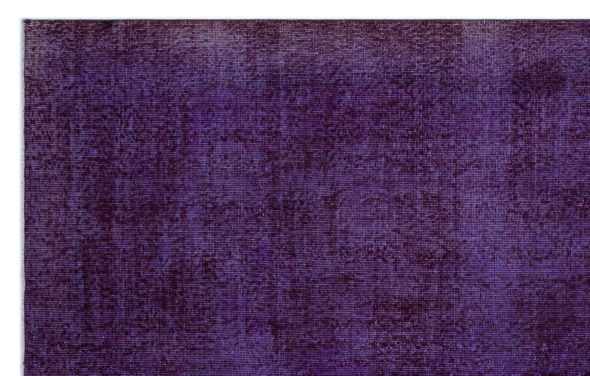Deep purple rug with a distressed, monochromatic texture and subtle tonal variations.