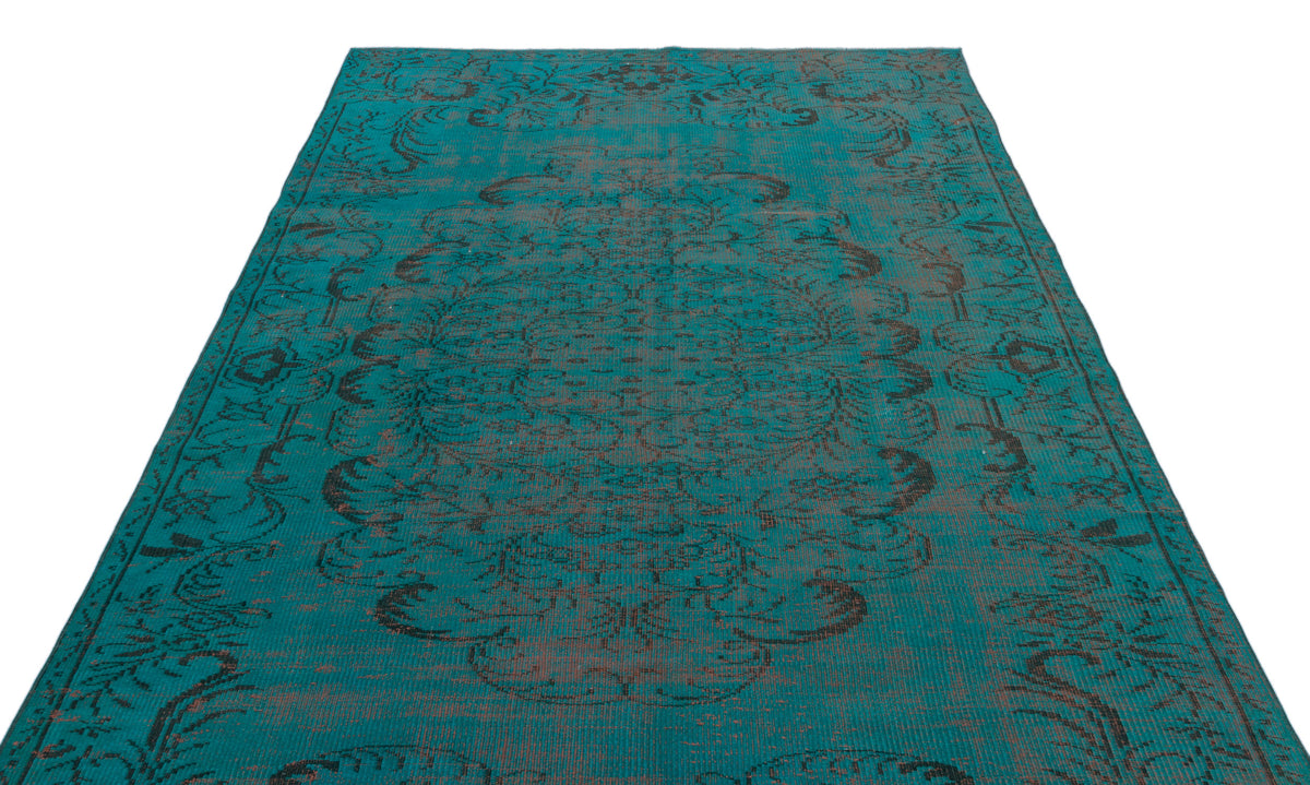 Teal and charcoal distressed rug with a traditional central medallion and ornate floral border pattern.