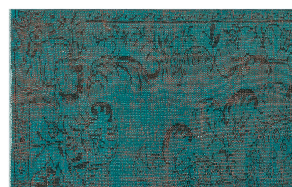 Teal and charcoal rug with a distressed, traditional floral medallion pattern.