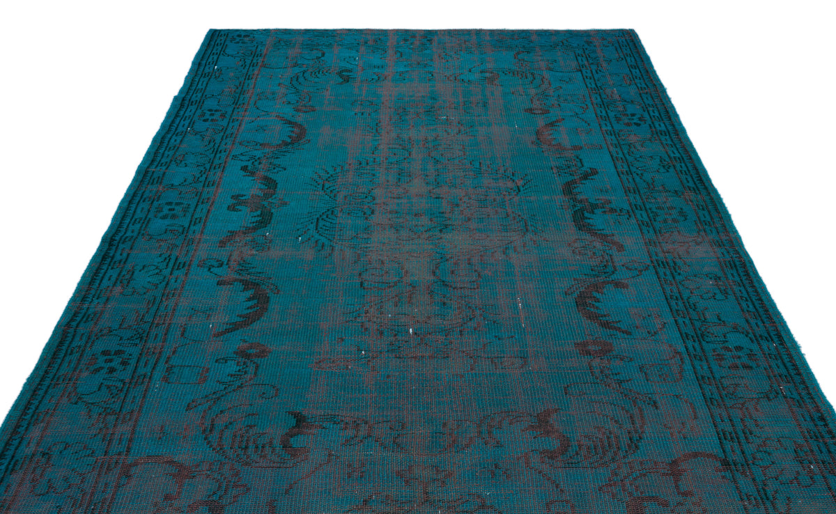 Teal and charcoal distressed vintage-style rug with an ornate central medallion and decorative border.