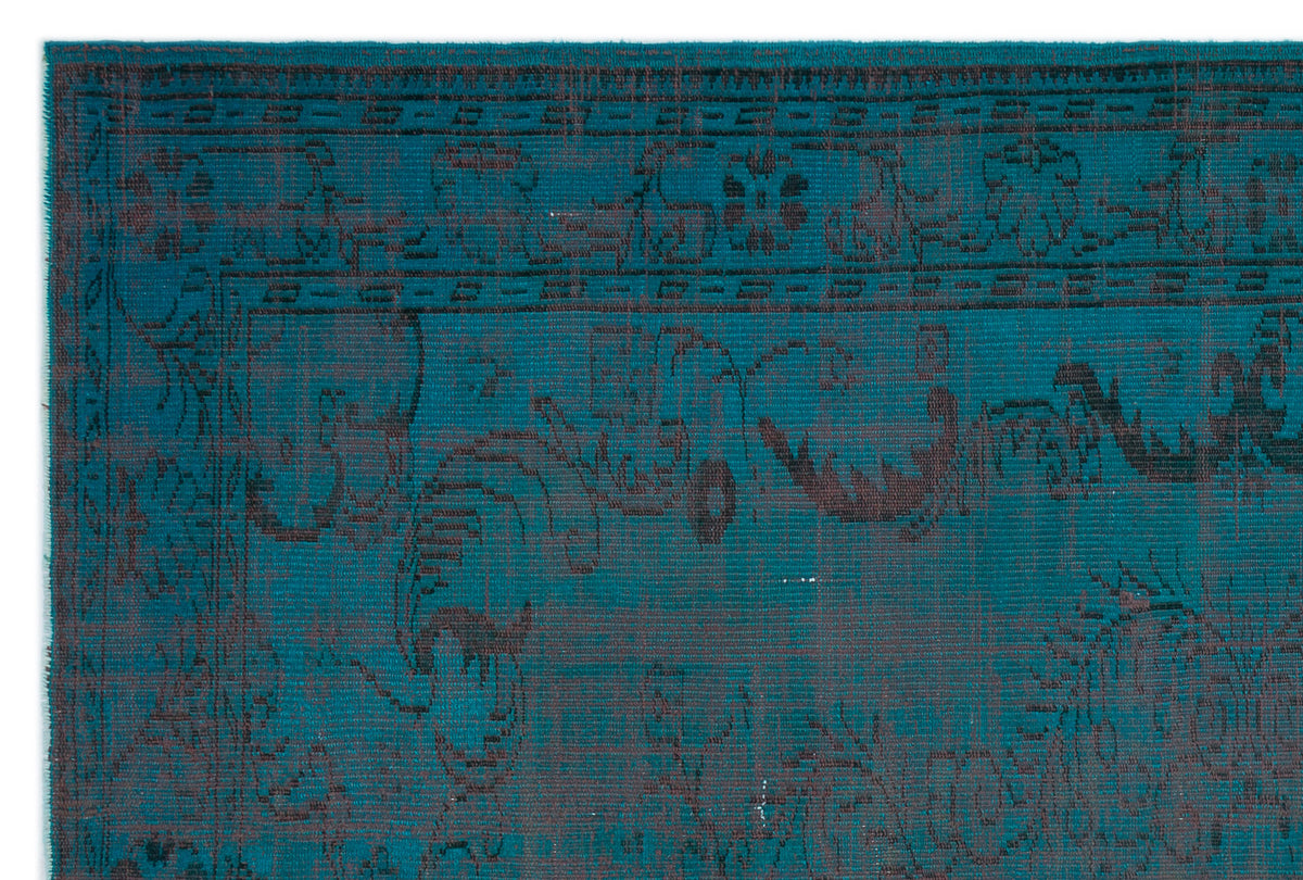 Teal and charcoal distressed rug with a traditional ornate border and floral medallion pattern.