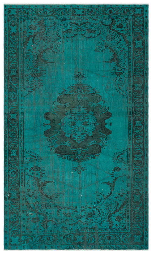 Load image 1 in gallery view. Teal and black distressed rug with a central floral medallion and ornate border pattern.