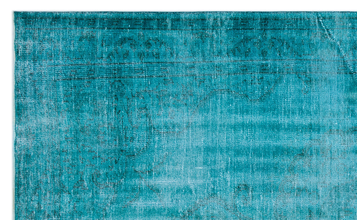 Teal distressed rug with a faded traditional medallion pattern on a white background.