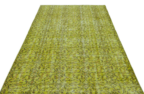 Load image 1 in gallery view. Chartreuse and brown vintage-style rug with a distressed, intricate floral medallion pattern on a white background.