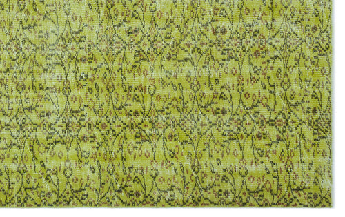 Load image 1 in gallery view. Chartreuse and olive green vintage-style rug with a distressed, intricate floral vine pattern.