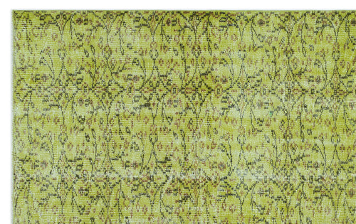 Load image 1 in gallery view. Chartreuse and brown distressed rug with a repeating vintage floral medallion pattern.