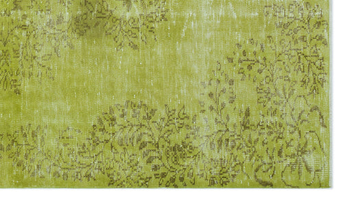 Load image 1 in gallery view. Chartreuse and olive green rug with a distressed, faded floral pattern.