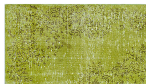 Load image 1 in gallery view. Chartreuse and olive green rug with a distressed, faded floral pattern.
